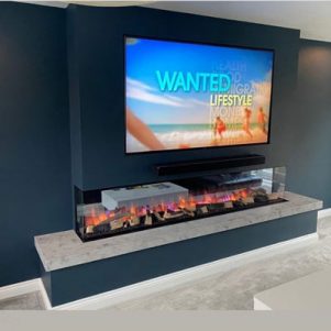 The largest electric fire currently available the Evonic GF3 2400 Electric fire Installed with Shadow grey stone plinth, Media Wall